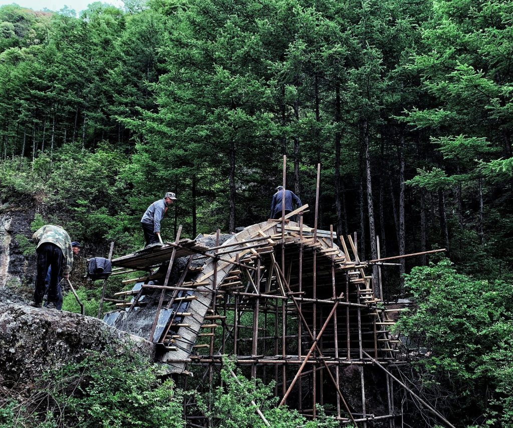 people walking on brown wooden bridge during daytime